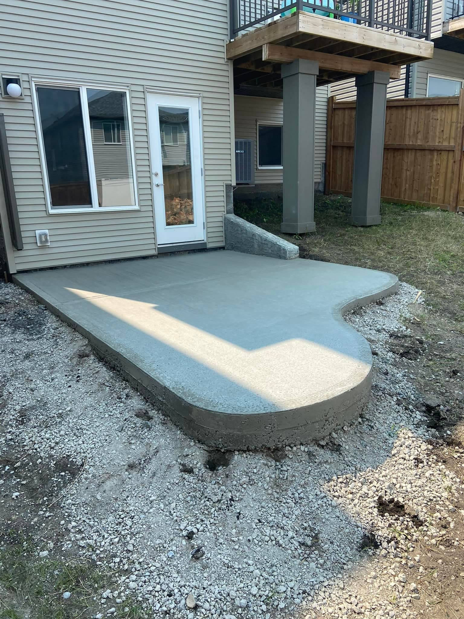 Curved concrete walkway leading to a home entrance